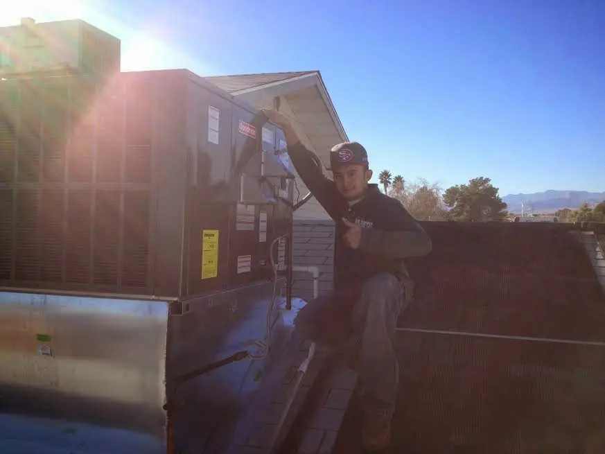 HVAC technician performing AC Tune-Up on a rooftop unit in Cypress Lake